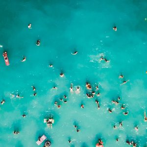 large group of people swimming at crab island from crab island journey